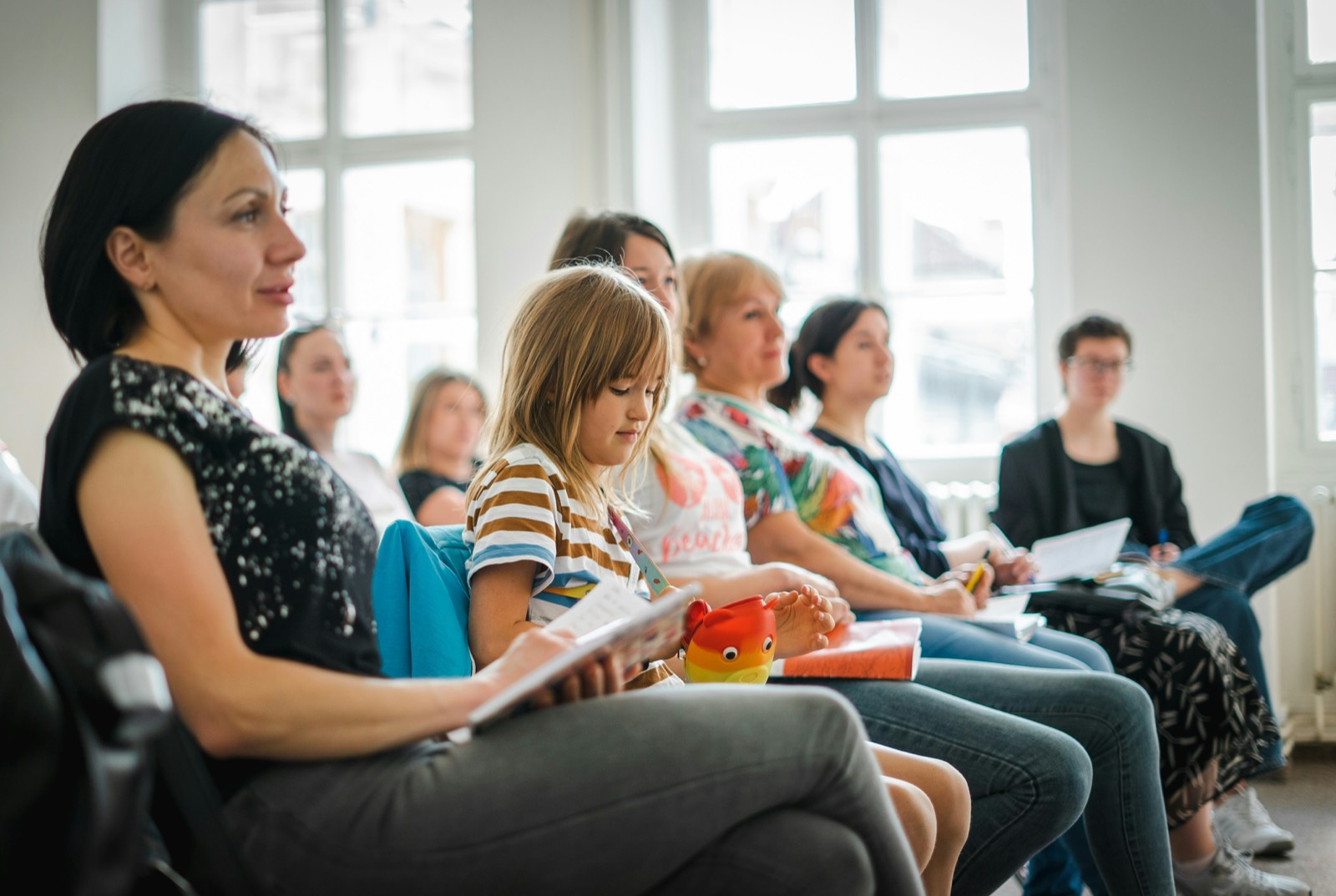 Adults taking notes during an educational workshop